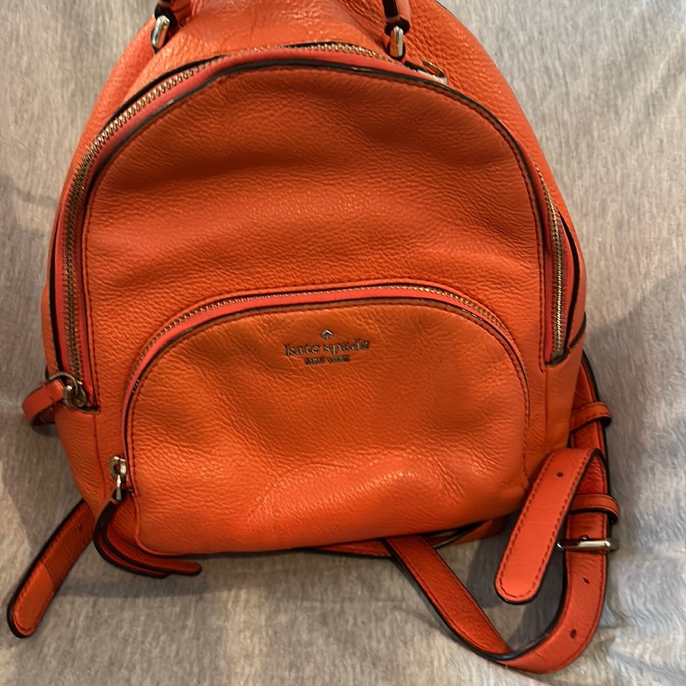 Kate Spade, adorable, orange, backpack with adjustable straps and outer pocket